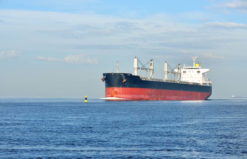Large cargo ship sailing in still water